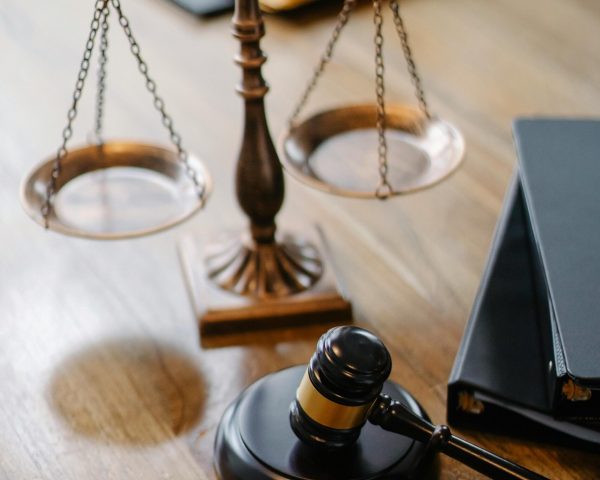 High angle lawyers desk with decorative judgement scales and gavel in modern law firm